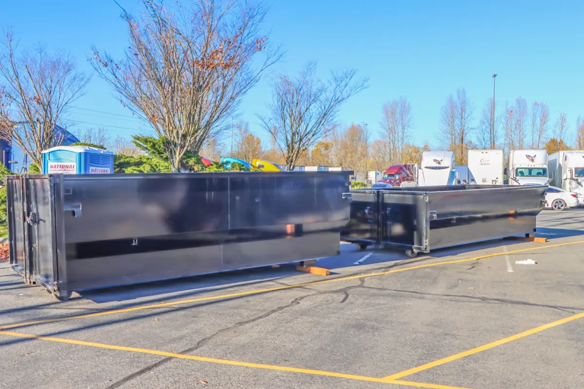 Professional dumpster rental service with roll-off container on residential driveway in Bernards